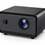 A modern black portable projector with a textured fabric front grille, a large central lens, and a small side sensor, shown on a clean white background.