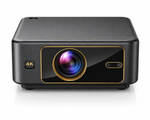 A black 4K ultra HD projector with gold trim accents, featuring a prominent circular lens and a small port on the front, set against a clean white background.